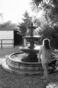 woman standing beside a water fountain