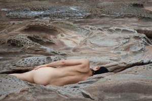 woman laying on rock formations