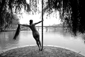 nude woman overlooking a bridge, black and white photo