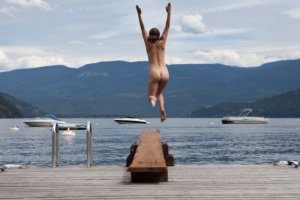 woman jumping in lake